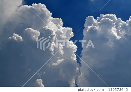 Towering Cumulus Clouds Against Deep Blue Sky Towering Cumulus Clouds Against Deep Blue Sky 139578643