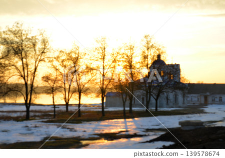 Sunset over snowy rural landscape with old building 139578674
