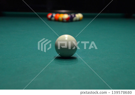 White cue ball on pool table with racked balls White cue ball on pool table with racked balls 139578680