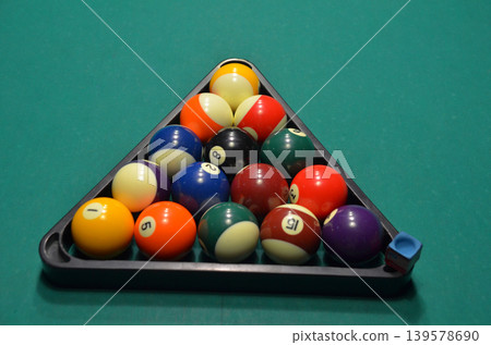 Triangle rack of colorful billiard balls on table Triangle rack of colorful billiard balls on table 139578690