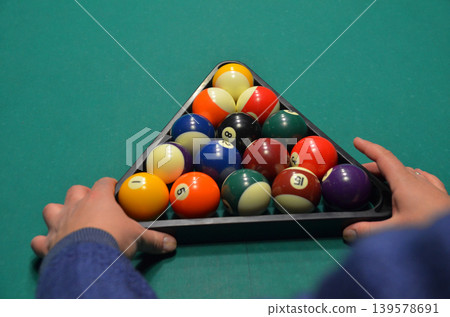 Hands Racking Billiard Balls on Pool Table Hands Racking Billiard Balls on Pool Table 139578691