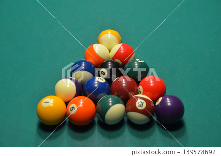 Rack of billiard balls on green pool table Rack of billiard balls on green pool table 139578692