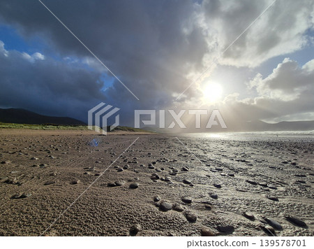 Dramatic cloudy beach landscape with sunbeams Dramatic cloudy beach landscape with sunbeams 139578701