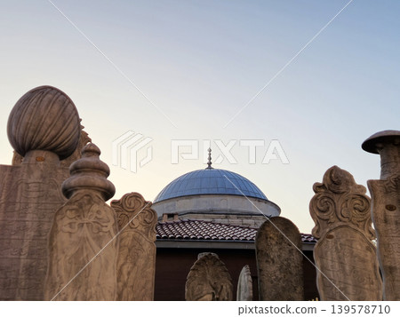 Stone carvings framing a blue dome against sky Stone carvings framing a blue dome against sky 139578710