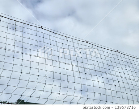 Wire fence against cloudy sky Wire fence against cloudy sky 139578716