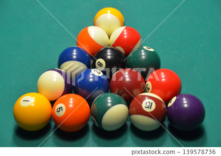 Rack of colorful billiard balls on green felt Rack of colorful billiard balls on green felt 139578736
