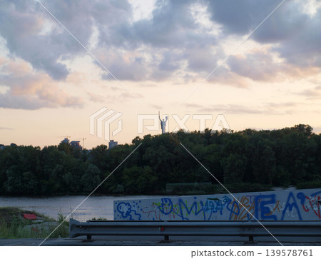 Distant statue above river at sunset Distant statue above river at sunset 139578761