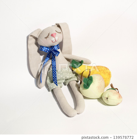 Handmade stuffed bunny with fruit toys on white Handmade stuffed bunny with fruit toys on white 139578772