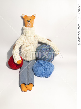 Handmade cat doll with colorful yarn balls 139578775