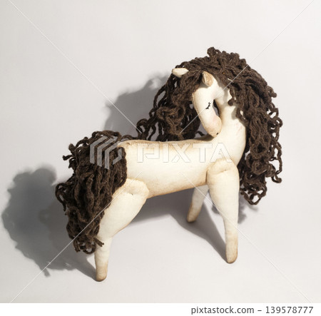 Handmade stuffed horse toy on white background Handmade stuffed horse toy on white background 139578777