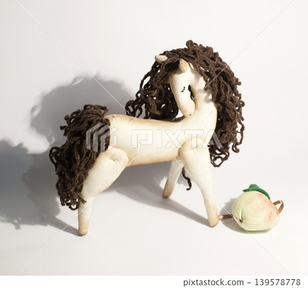 Handmade toy horse with apple on white background 139578778