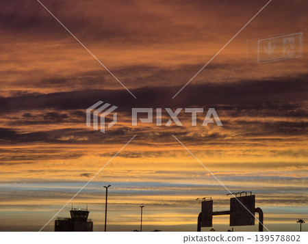 Dramatic Sunset Sky Over Airport Silhouettes Dramatic Sunset Sky Over Airport Silhouettes 139578802