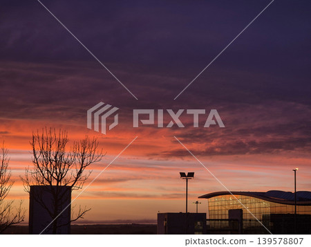 Dramatic sunset sky over modern building silhouette Dramatic sunset sky over modern building silhouette 139578807