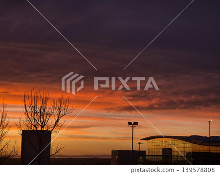 Dramatic sunset sky above modern glass building Dramatic sunset sky above modern glass building 139578808