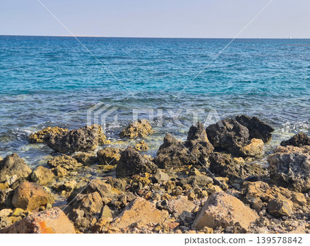 Rocky Seashore with Calm Blue Ocean Rocky Seashore with Calm Blue Ocean 139578842