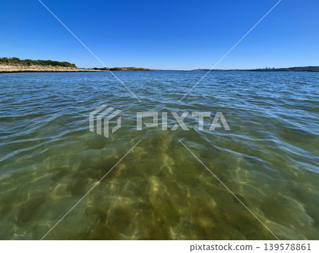 Clear Coastal Water with Distant Shoreline Clear Coastal Water with Distant Shoreline 139578861