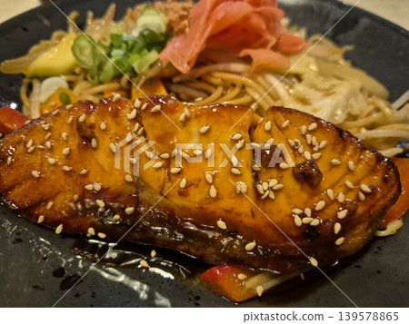 Glazed salmon with noodles and sesame seeds 139578865