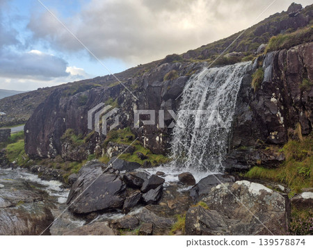 Waterfall Cascading Over Rocky Mountainside Waterfall Cascading Over Rocky Mountainside 139578874