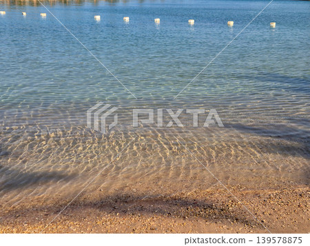 Clear Shallow Water Along a Sandy Shore 139578875