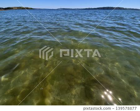Clear coastal water with ripples and shoreline Clear coastal water with ripples and shoreline 139578877