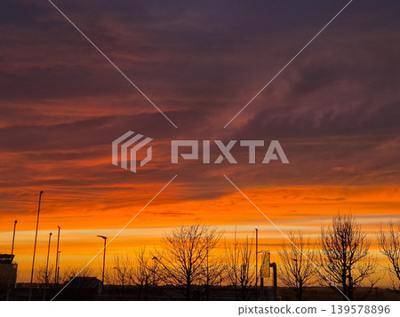 Dramatic orange sunset over silhouetted trees Dramatic orange sunset over silhouetted trees 139578896