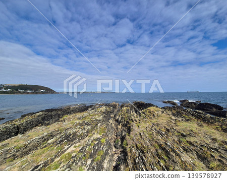 Rocky coastal landscape under cloudy blue sky Rocky coastal landscape under cloudy blue sky 139578927