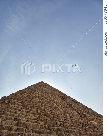 Ancient stone pyramid under clear blue sky Ancient stone pyramid under clear blue sky 139578949