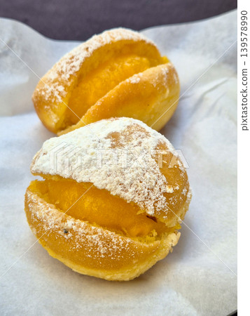 Powdered sugar filled pastries on parchment paper 139578990