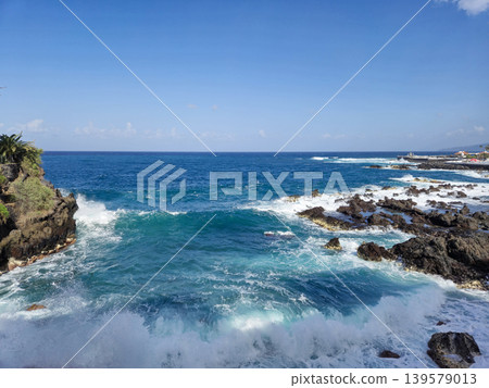 Ocean Waves Crashing Against Rocky Coastline Ocean Waves Crashing Against Rocky Coastline 139579013