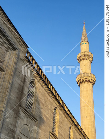 Historic mosque minaret against clear blue sky Historic mosque minaret against clear blue sky 139579044