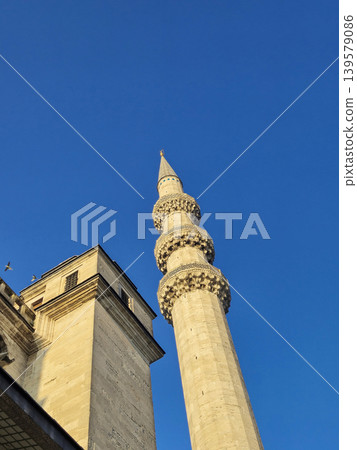 Historic mosque minaret against clear blue sky Historic mosque minaret against clear blue sky 139579086