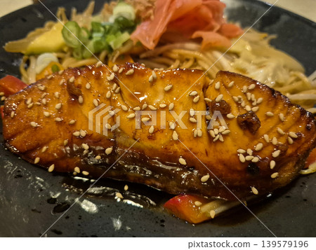Glazed grilled fish with sesame over noodles Glazed grilled fish with sesame over noodles 139579196
