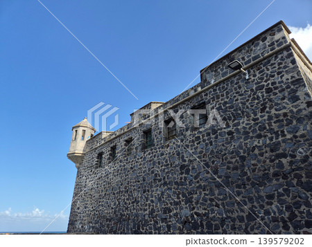 Historic stone fortress wall under clear blue sky 139579202