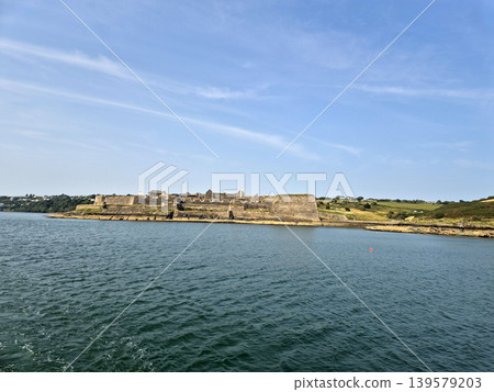 Seaside fortress overlooking calm blue water 139579203