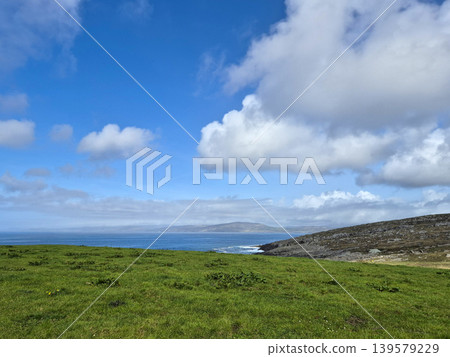 Green coastal landscape with blue sky and clouds Green coastal landscape with blue sky and clouds 139579229