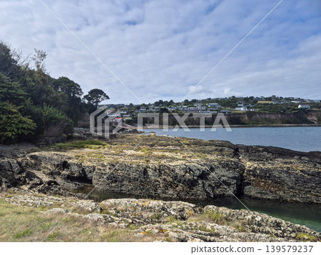 Rocky Coastal Landscape With Distant Houses Rocky Coastal Landscape With Distant Houses 139579237