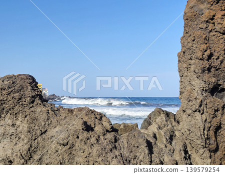 Rocky coastline with ocean waves and blue sky Rocky coastline with ocean waves and blue sky 139579254