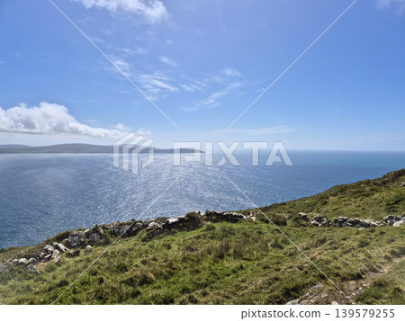Sunny coastal landscape with ocean and grassy cliffs Sunny coastal landscape with ocean and grassy cliffs 139579255