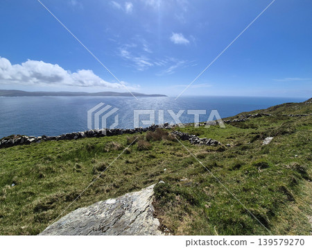 Coastal cliff overlooking calm blue ocean Coastal cliff overlooking calm blue ocean 139579270