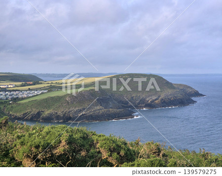 Coastal headland with cliffs and calm sea Coastal headland with cliffs and calm sea 139579275