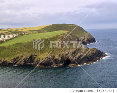 Coastal cliff and grassy headland above the sea 139579281