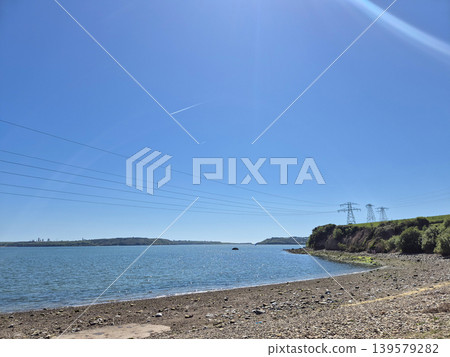 Quiet coastal bay under clear blue sky Quiet coastal bay under clear blue sky 139579282