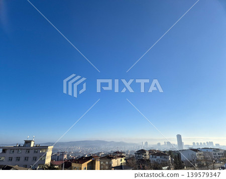 Clear blue sky over distant city skyline 139579347