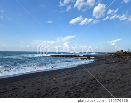 Black Sand Beach with Waves and Blue Sky Black Sand Beach with Waves and Blue Sky 139579386