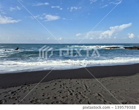Black Sand Beach with Waves and Blue Sky Black Sand Beach with Waves and Blue Sky 139579388