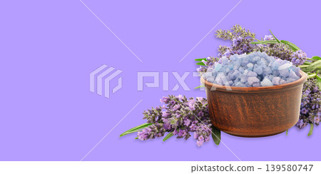 Lavender flowers and crystals sit in a wooden bowl 139580747