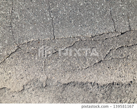 Cracked old asphalt texture - close-up of aged road surface and cracks Cracked old asphalt texture - close-up of aged road surface and cracks 139581167