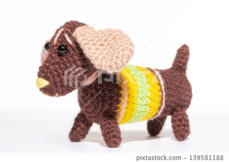 Knitted woolen dog on a white background Knitted woolen dog on a white background 139581188