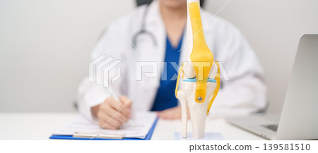 Doctor with Human Knee joint anatomy model. Osteoarthritis, Patellofemoral Pain Syndrome, Patellar Tendinitis, ACL, Anterior Cruciate Ligament, PCL, Posterior, MCL, Medial Collateral, LCL and Lateral Doctor with Human Knee joint anatomy model. Osteoarthritis, Patellofemoral Pain Syndrome, Patellar Tendinitis, ACL, Anterior Cruciate Ligament, PCL, Posterior, MCL, Medial Collateral, LCL and Lateral 139581510