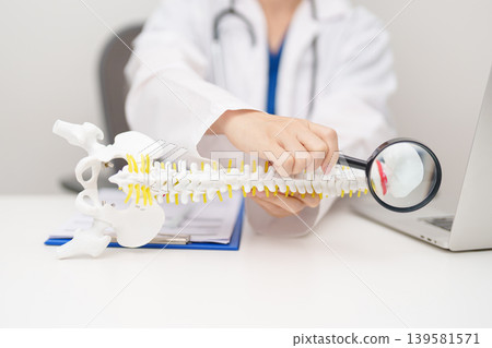 Doctor with human Spine anatomy model. Spinal Cord Disorder and disease, Back pain, Lumbar, Sacral pelvis, Cervical neck, Thoracic, Coccyx, Orthopedist, chiropractic, Office Syndrome and health Doctor with human Spine anatomy model. Spinal Cord Disorder and disease, Back pain, Lumbar, Sacral pelvis, Cervical neck, Thoracic, Coccyx, Orthopedist, chiropractic, Office Syndrome and health 139581571